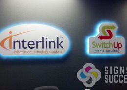 Interlink and SwitchUp Web added shaped PVC signs with LED lighting in back, looks great, by Signs for Success, lighted wall signs