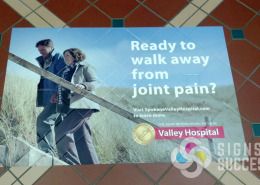 Advertise on the floor with vinyl that contours to the tile, like these at Spokane Valley Hospital for Allegra
