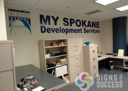City of Spokane My Spokane Development Services logo on wall for added impact and signage without taking up space, cover bare wall with messages or logo