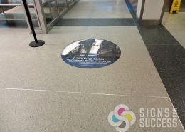 Riverpark Square added ads to the floor at Spokane International Airport with specially printed, laminated graphics that come off easily later, very nice by Signs for Success