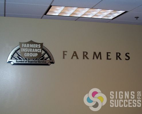 Lobby sign for Farmers Insurance, cut acrylic with metal laminate for lobby wall sign in offices, by Signs for Success