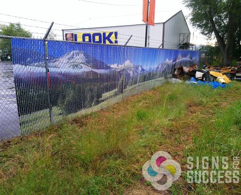 You can even hide the mess next door with custom printed chain link privacy slats like this Spokane Business did, by Signs for Success, call now for a fast, free quote