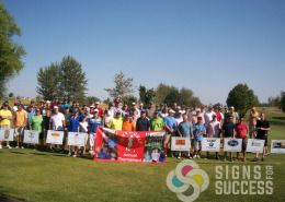Advertisers and sponsors with banners at Gift of Golf Tournament in Post Falls and Cheney