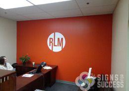 Real Life Ministries Spokane has their "orb" logo on office wall, by Signs for Success