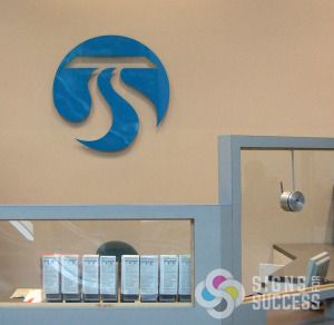 Dimensional acrylic plexiglass lobby sign for Spokane Transit, exact cyan pantone match by Signs for Success