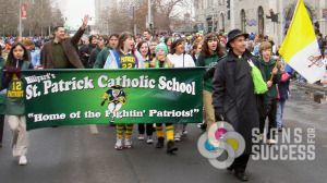 Parade banner for St. Patrick Catholic School's annual event includes bright colors and pole pockets