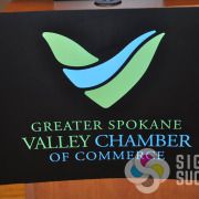 Greater Spokane Valley Chamber needed a podium sign for the unveiling of their new logo design, with White and colored inks on black PVC sintra, this one looks great, custom signs spokane