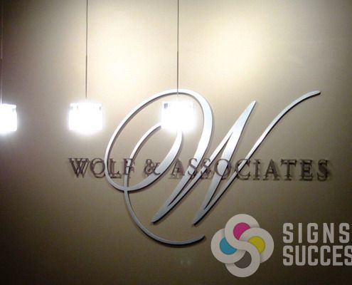 Lobby signs of dimensional letters look great on the wall like this one for Wolf & Associates in Spokane, of cut metal and acrylic