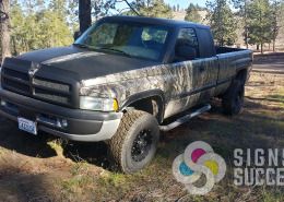 John's matte black and camouflage wrap on Dodge pickup truck by Signs for Success in Spokane